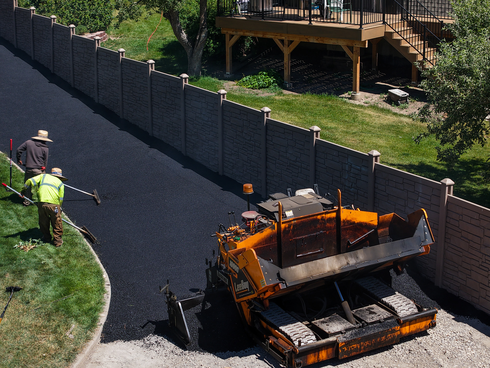 J&C Asphalt crew paving a residential driveway in Utah Valley
