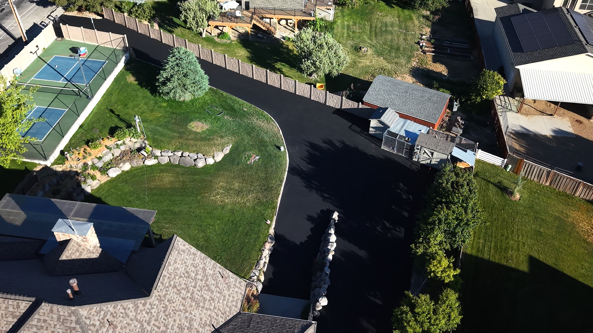 Completed residential driveway paved by J&C Asphalt, aerial view