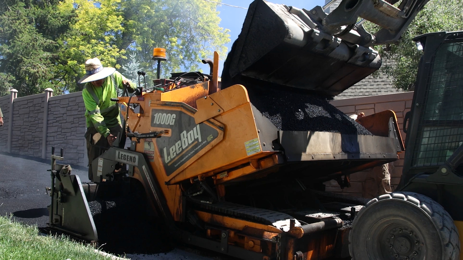 J&C Asphalt paving crew at work on an Orem, UT driveway